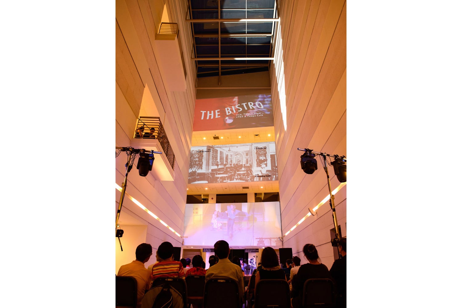 The third concert, The Bistro, took place in the open space of the YST ground level walkway, with light projections on the central white walls of the YST building.