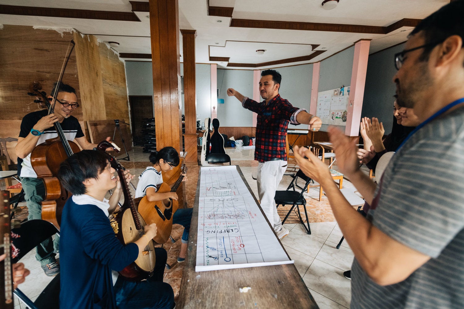 Working with the Singapore International Foundation and musicians from the Bandung Philharmonic, to empower Afghan refugees living in Indonesia to express themselves creatively through music (frontmost on left).Photo by Singapore International Foundation.